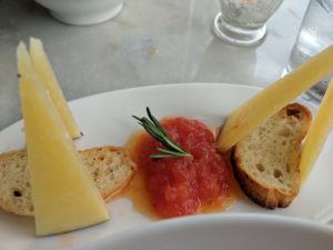 a plate of food with a slice of bread and sauce