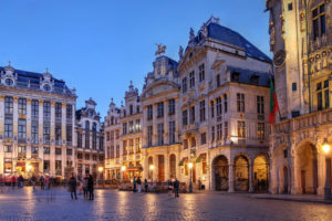 a group of people walking in Grand Place