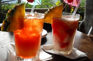 two drinks with umbrellas and straws