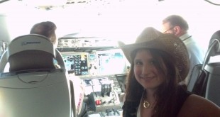 a woman in a cowboy hat in a cockpit