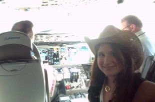 a woman in a cowboy hat in a cockpit