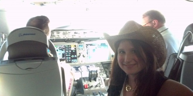 a woman in a cowboy hat in a cockpit