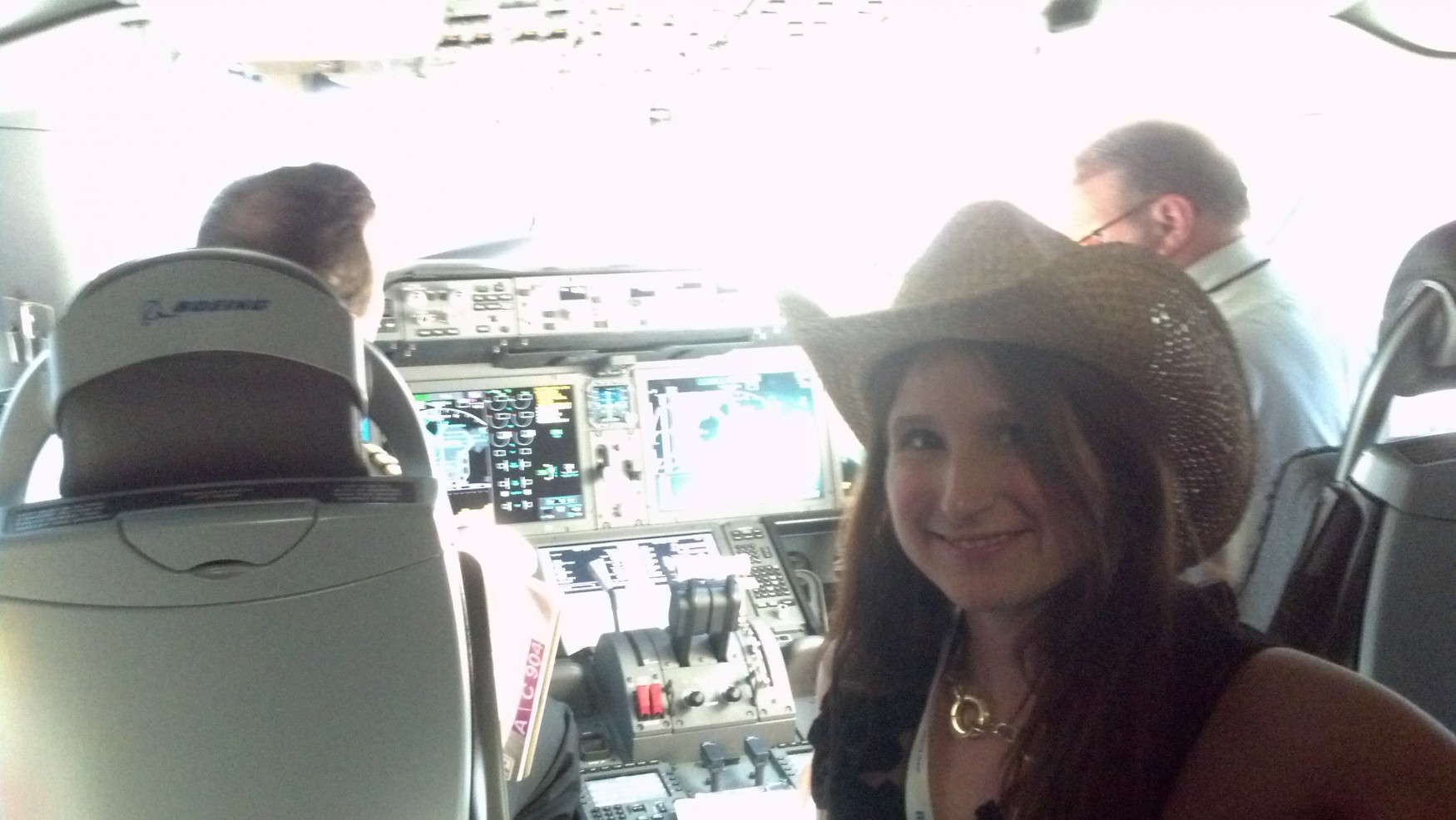 a woman in a cowboy hat in a cockpit