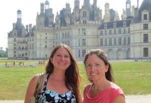 a couple of women standing in front of a castle