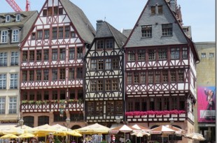 a group of buildings with people walking around