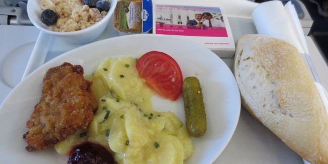 a plate of food and a bowl of bread