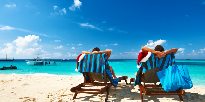 two people sitting in chairs on a beach