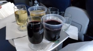 a tray of drinks on a plane