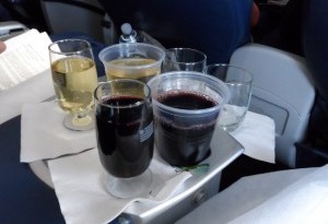 a tray of drinks on a plane