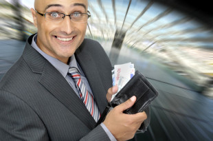 a man holding a wallet full of money