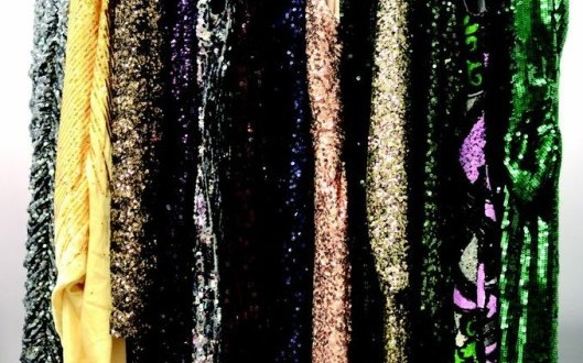a group of sequins on a rack