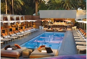 a pool with lounge chairs and lounge chairs