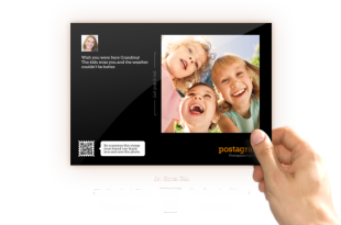 a hand holding a photo of a group of children