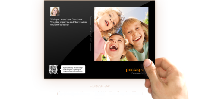 a hand holding a photo of a group of children