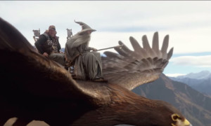 two men riding a bird
