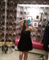 a woman taking a selfie in a mirror