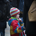 a child in a colorful hat and coat