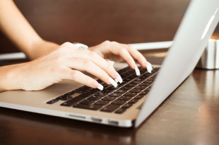 a person typing on a laptop