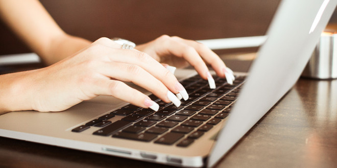 a person typing on a laptop