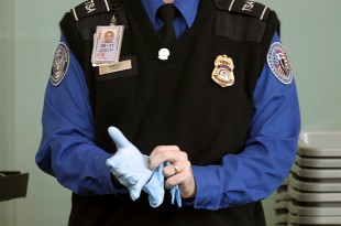 a police officer wearing a blue shirt and blue gloves