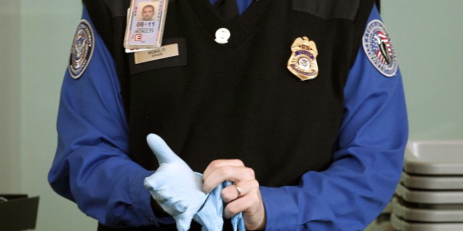 a police officer wearing a blue shirt and blue gloves