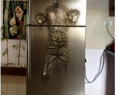 a silver refrigerator with a human figure on it