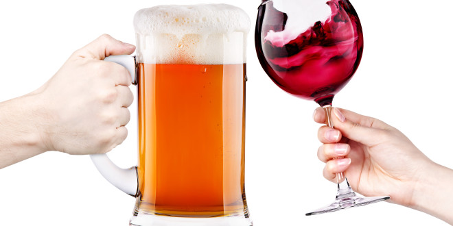 a hand holding a glass of beer