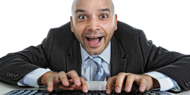 a man in a suit and tie typing on a keyboard