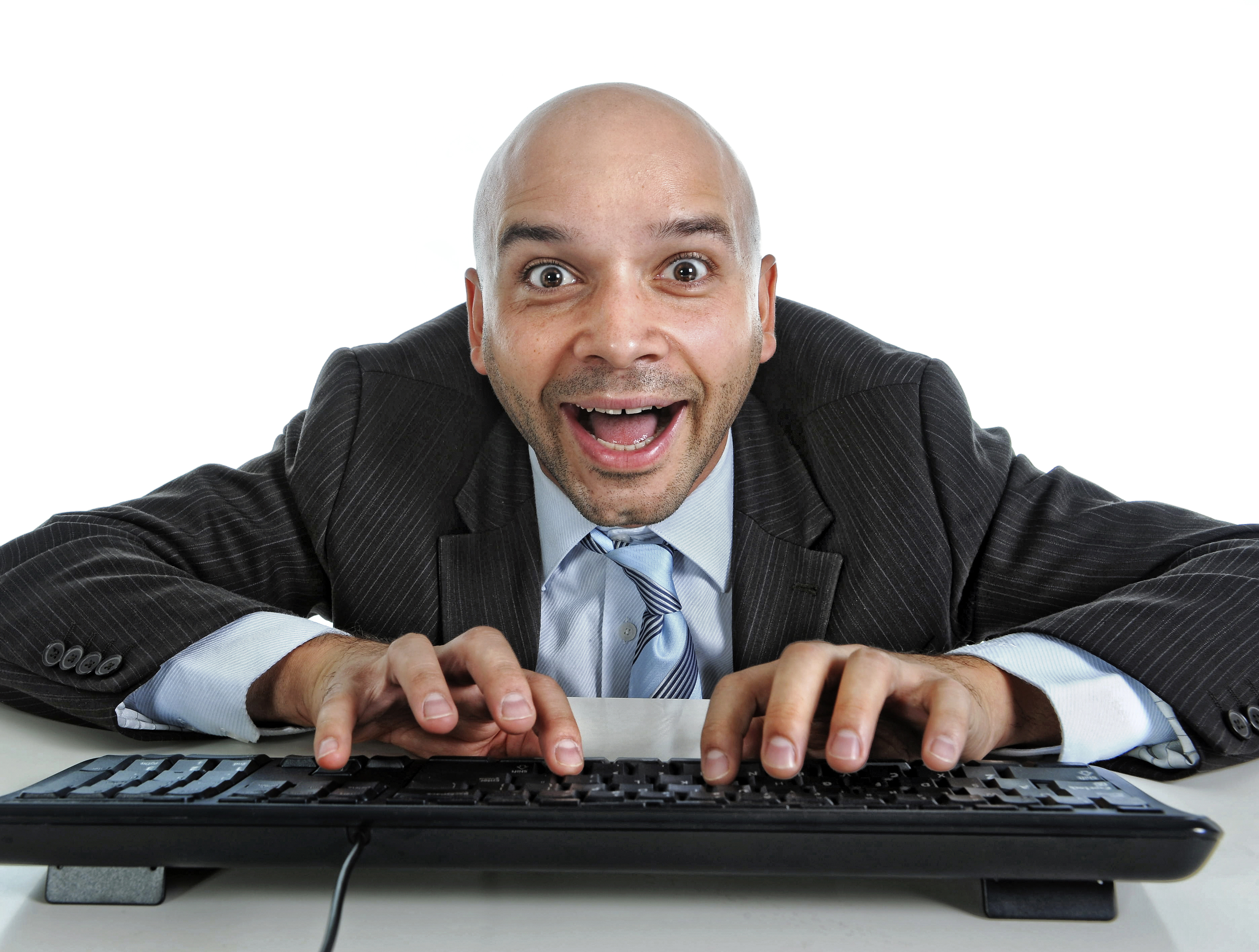 a man in a suit and tie typing on a keyboard
