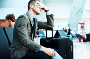 a man sitting with his hand on his face