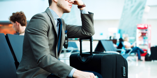 a man sitting with his hand on his face