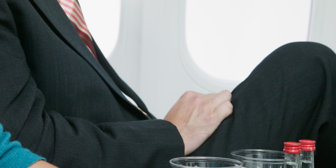 a man sitting in an airplane with ice