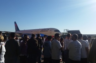 a group of people standing around an airplane
