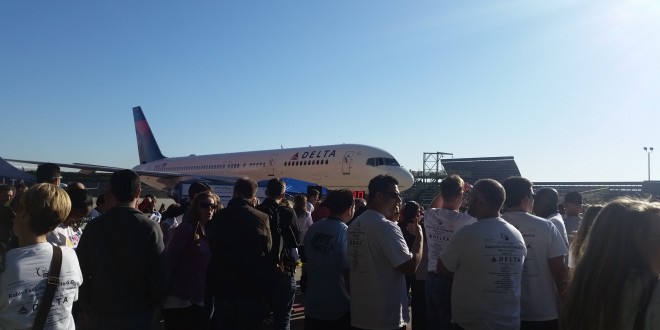 a group of people standing around an airplane