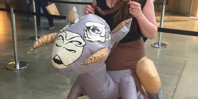 a woman holding a large inflatable animal