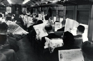 a group of people on a train reading newspapers