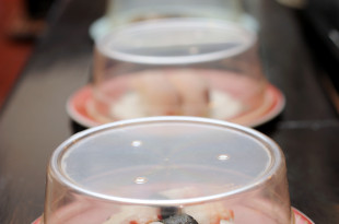 a row of plastic containers with food on them