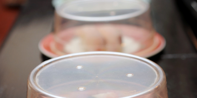 a row of plastic containers with food on them