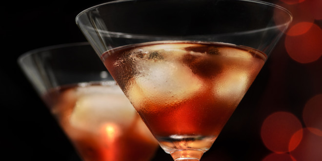 a pair of glasses with ice and liquid in it