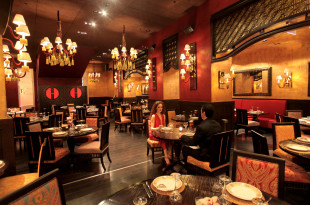 a man and woman sitting at a table in a restaurant