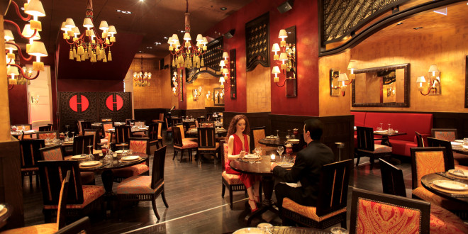 a man and woman sitting at a table in a restaurant