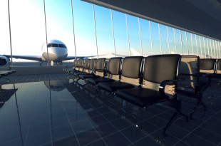 a row of chairs in a room with a plane in the background