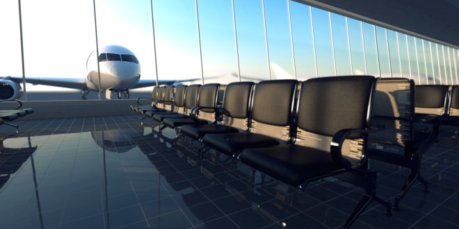 a row of chairs in a room with a plane in the background