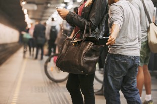 a woman holding a bag and a man standing next to her