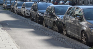 a row of cars parked on a street
