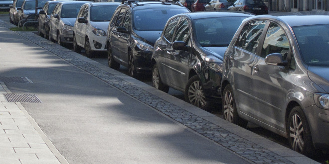 a row of cars parked on a street