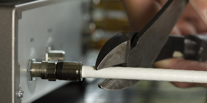 a person cutting a cable