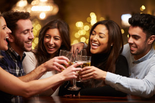 a group of people clinking glasses