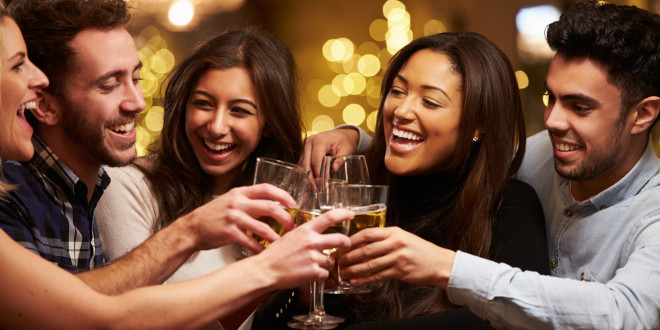 a group of people clinking glasses