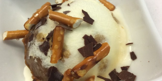 a bowl of ice cream with pretzels and chocolate chips